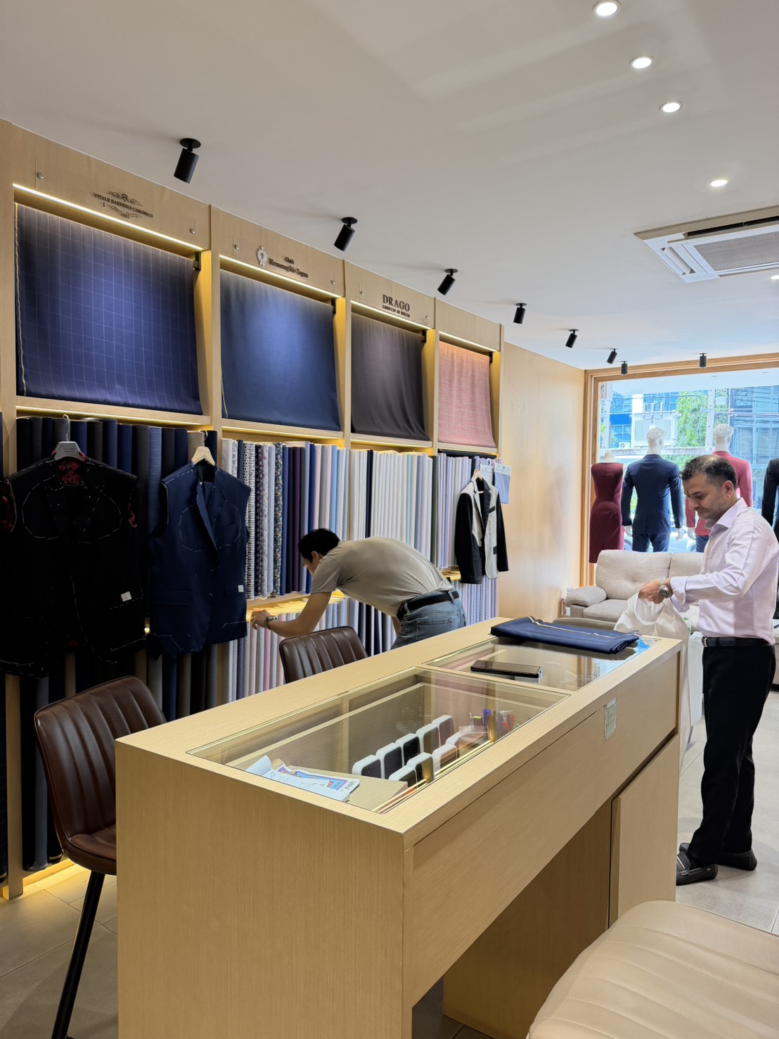 Tailor working with clients at Class Bespoke Tailor Bangkok